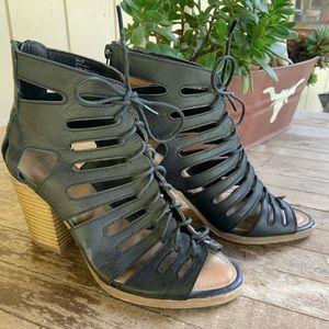 Lace up black heeled booties.